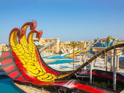 Bunte Wasserrutschen mit Drachenmotiv in einem Freizeit- und Wasserpark bei Sonnenlicht.