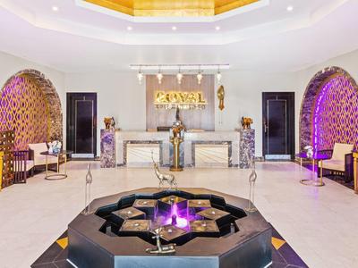 Elegant lobby with central fountain and spacious, bright seating areas bathed in warm light.