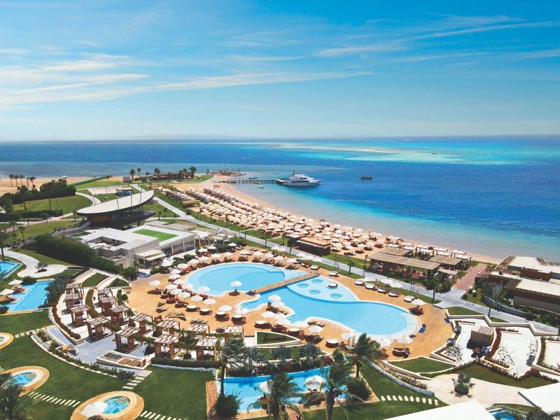 Aerial view of a resort with multiple pools and direct sea access.