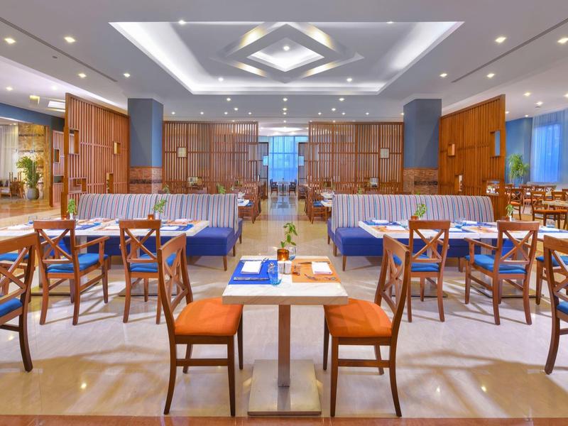 Eleganter Restaurantbereich mit Holzmöbeln und warmem Licht in einem Hotel.