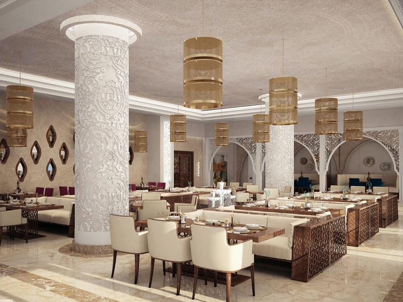 Elegant modern dining area with white columns and beige chairs in a hotel.