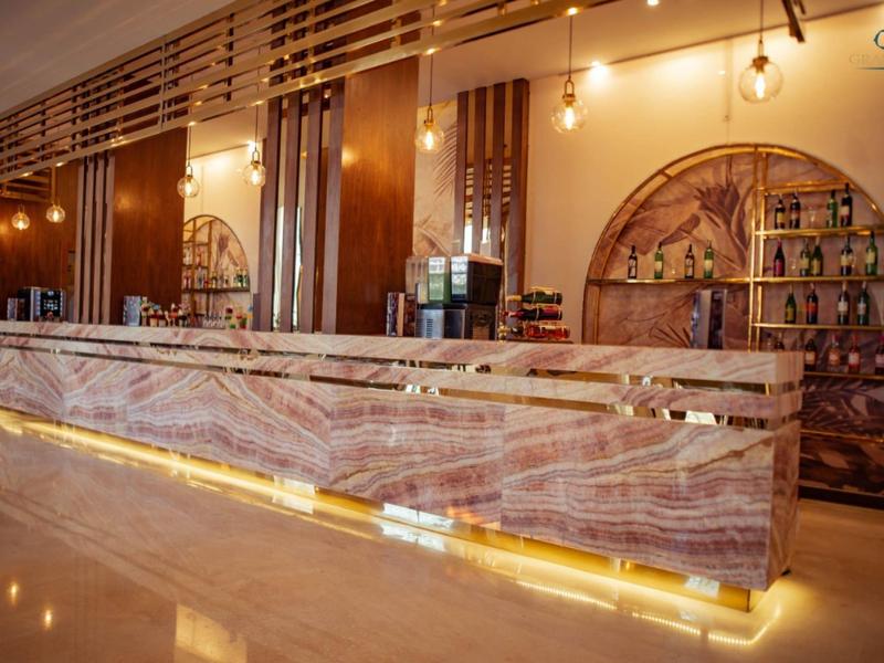 Modern hotel bar with illuminated wooden counter and stylish background design