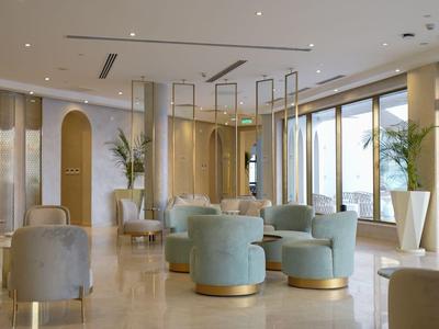 Elegant hotel lounge area with comfortable seating and large windows offering views.
