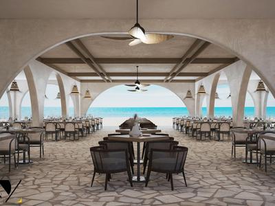 Otwarta jadalnia z widokiem na morze pod dużym łukiem z kamienną podłogą i drewnianymi meblami.