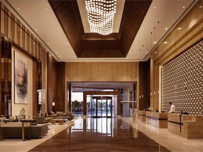 Elegant hotel lobby with seating areas, ornate lighting fixture, and wood accents.