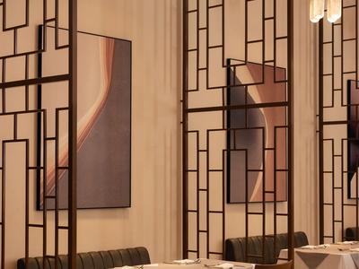 Elegant hotel seating area with modern wooden panels and stylishly set tables.