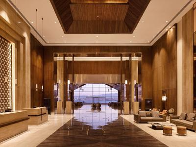 Spacious hotel lobby with bright lighting, luxurious seating, and wide view of the surroundings.