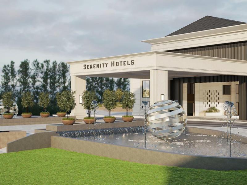 A spherical fountain is in front of the Serenity Hotel on a large terrace.