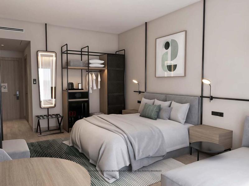 Modernes Hotelzimmer mit Doppelbett, Sitzbereich und minimalistischem Dekor in hellen Farben.