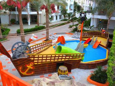 Aire de jeux aquatique pour enfants avec thème de bateau et jeux d'eau colorés dans un hôtel.