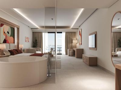 Modernes Hotelzimmer mit Sitzbereich, großem Bett und Balkon mit Meerblick.
