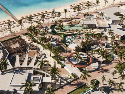 Luftaufnahme eines tropischen Resorts mit Pools, Palmen und Sandstrand.