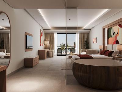 Modernes Hotelzimmer mit Doppelbett, Sitzbereich und Balkon mit Meerblick.