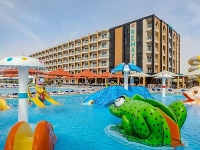 Großes Hotel mit ansprechend gestaltetem Außenpool und bunten Wasserspielen für Kinder.