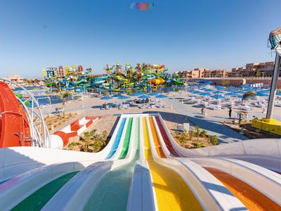 Bunte Wasserrutschen und Pools in einem sonnigen Wasserpark an einem Hotelresort.