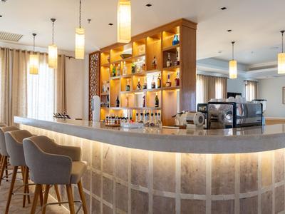 Modern hotel bar with high chairs and warm lighting
