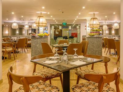 Restaurante elegante con diseño moderno y mesas puestas bajo luz cálida.