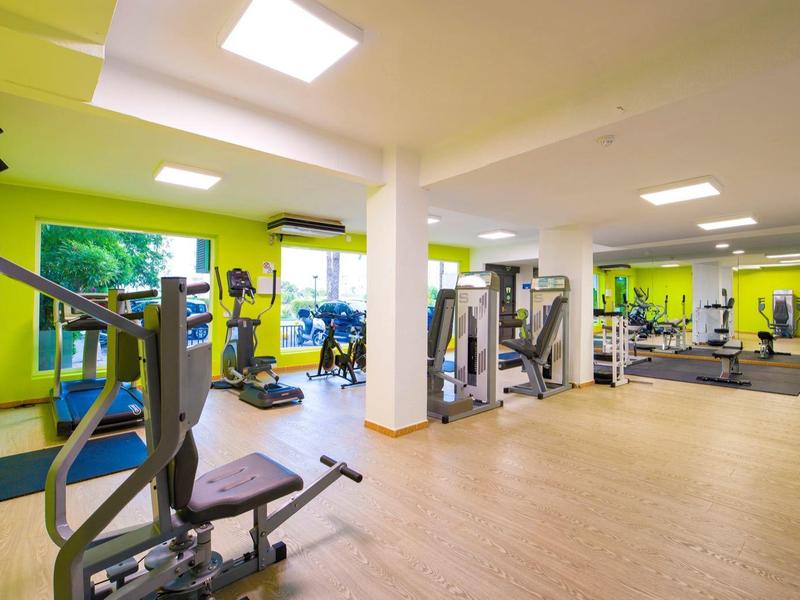 Moderne sportschool met diverse fitnessapparaten en heldere muren.