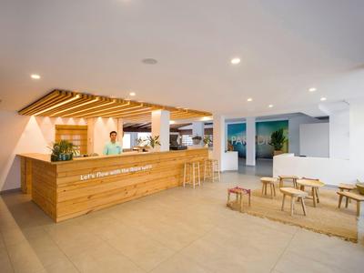 Lichte receptie met houten balie en lounge-meubilair in modern hotelinterieur