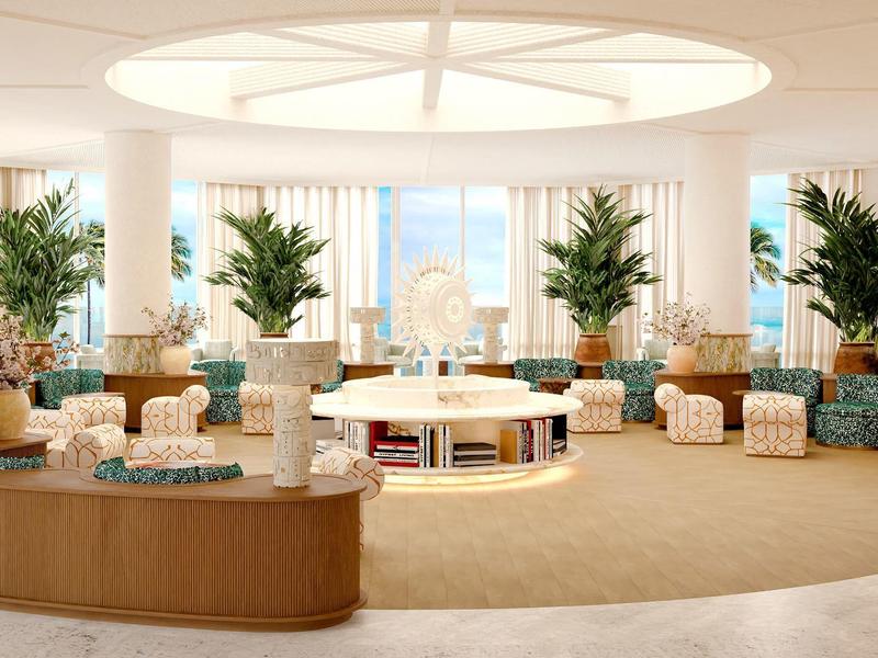Bright, modern hotel lounge with plants and armchairs.