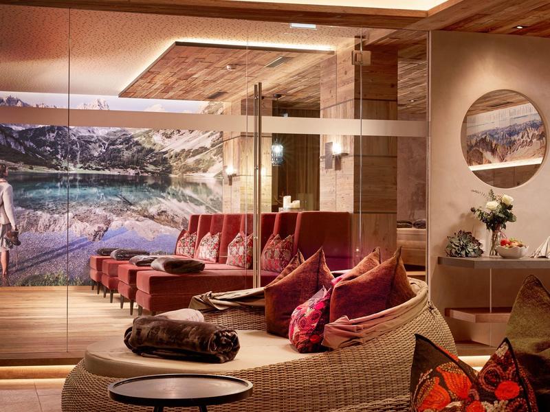 Modern hotel lounge with cozy wicker chairs, cushioned seating, and decorative pillows.