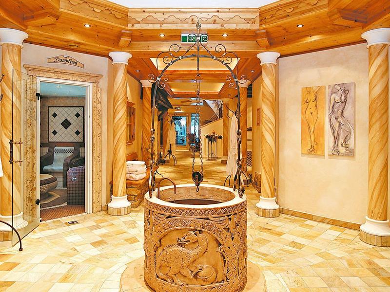 Luxe hotelinterieur met een prachtig versierde put en elegante marmeren zuilen.