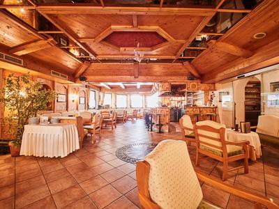Comedor rústico con muebles de madera y grandes ventanales