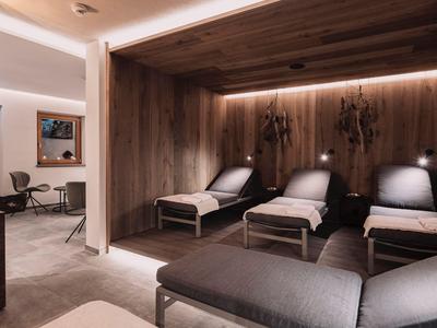 Modern relaxation area with comfortable loungers and wooden walls in a wellness hotel.