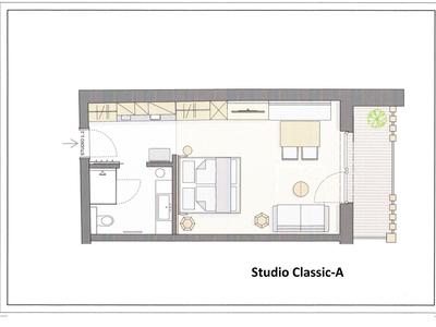 Grundriss eines Studioapartments mit Schlafzimmer, Bad, Küchenzeile und Balkon.
