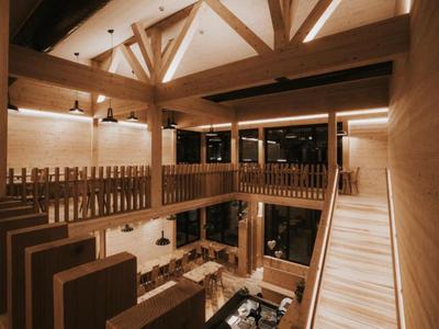 Innenansicht eines modernen Hotels mit Holzstruktur und offener Galerie.
