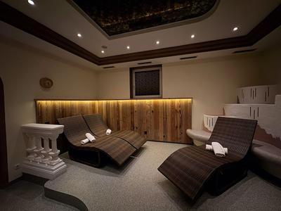 Modern spa with two loungers, subdued lighting, and a relaxing atmosphere.