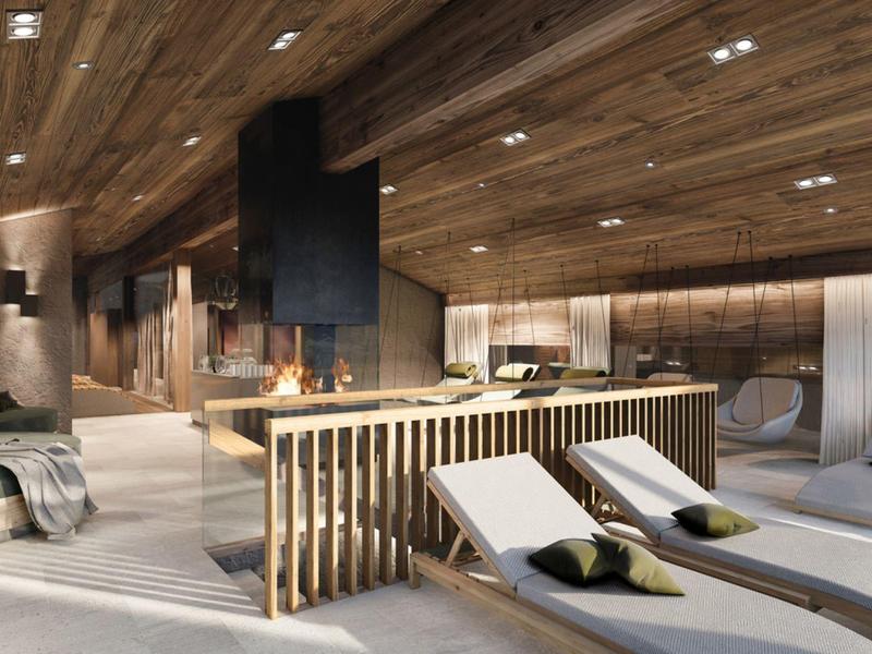 Moderner Wellnessbereich mit Holzbalken, Liegen und warmen Lichtakzenten in hellem und dunklem Holz.