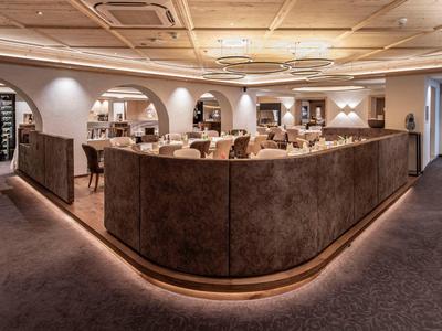 Elegant hotel restaurant area with comfortable booths and soft lighting.