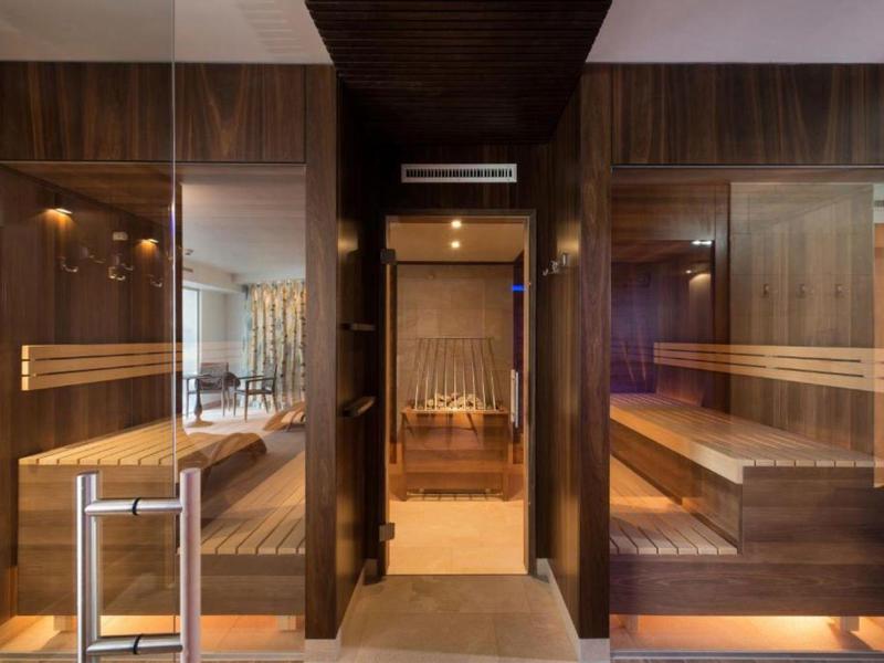 Modern interior with wooden sauna and seating in a hotel.