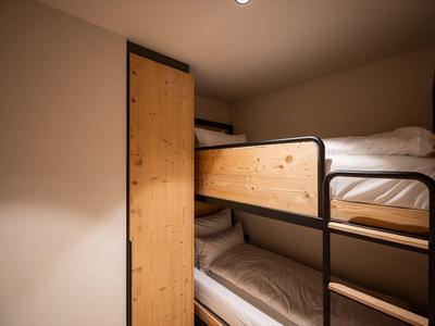 Cozy room with wooden bunk beds and warm lighting on beige walls.