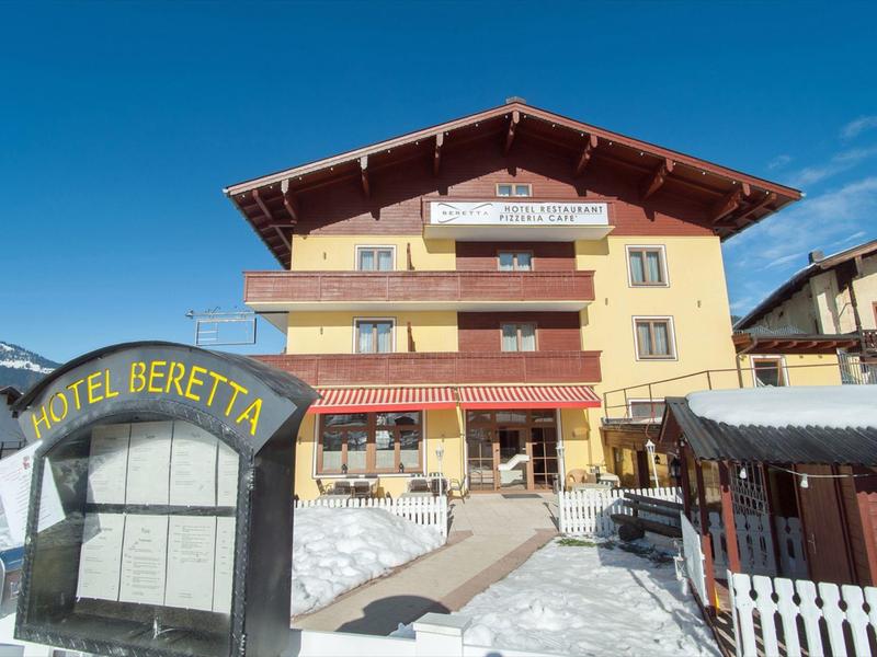 Hotel Beretta in snowy mountain landscape under clear sky