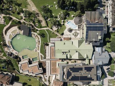 Aerial view of a hotel complex with swimming pools and green areas