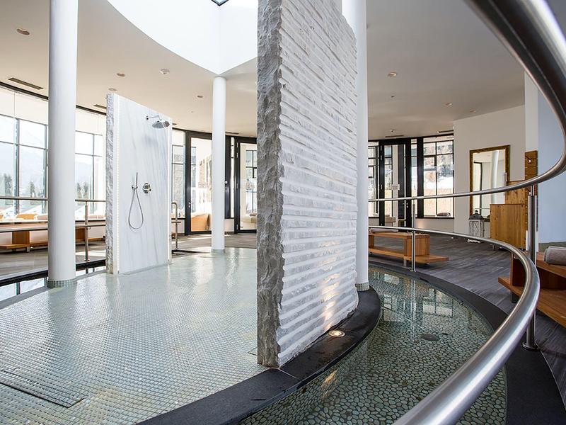 Modern hotel lobby with circular water feature and large windows letting in natural light