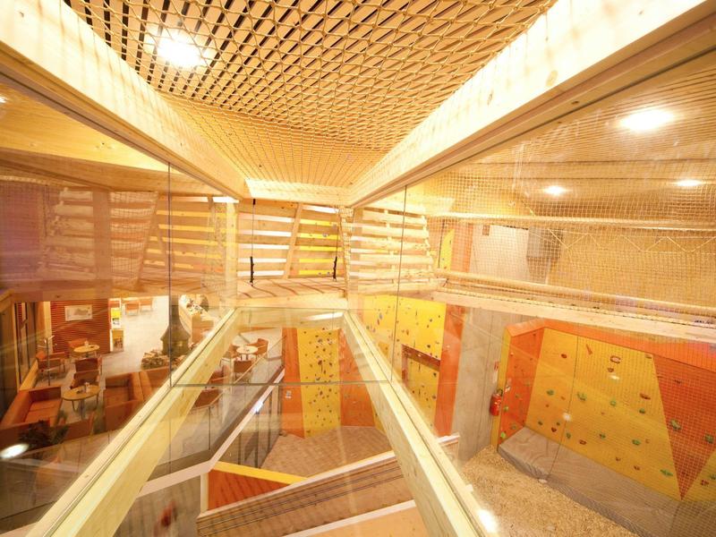 Modern interior with stairs, glass railings, and light wood decor in a building.