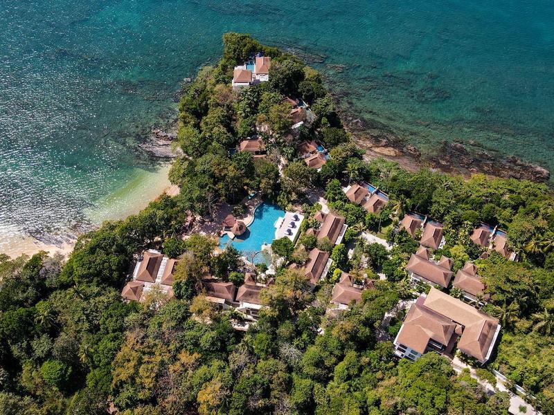 Luftaufnahme einer tropischen Insel mit Hotel, Pool und üppiger Vegetation umgeben von türkisfarbenem Wasser
