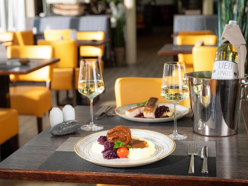 Elegant restaurant table with two wine glasses and a plated gourmet dish.