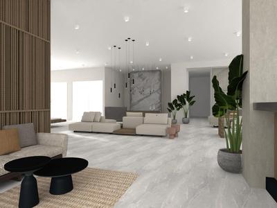 Moderner heller Wohnraum mit grauem Sofa, schwarzem Couchtisch und grünen Pflanzen.