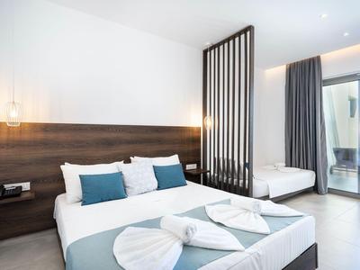 Modernes Hotelzimmer mit Doppelbett, Einzelbett, Holzakzenten und Balkon mit Vorhängen.