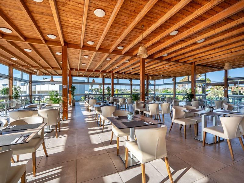 Bright restaurant with wooden ceiling and large windows letting in plenty of daylight.