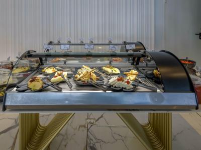 Buffet with various snacks and sandwiches in a modern hotel setting.