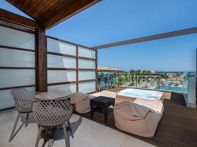 Terrace living area with seating, lounge chair, and view of city and water