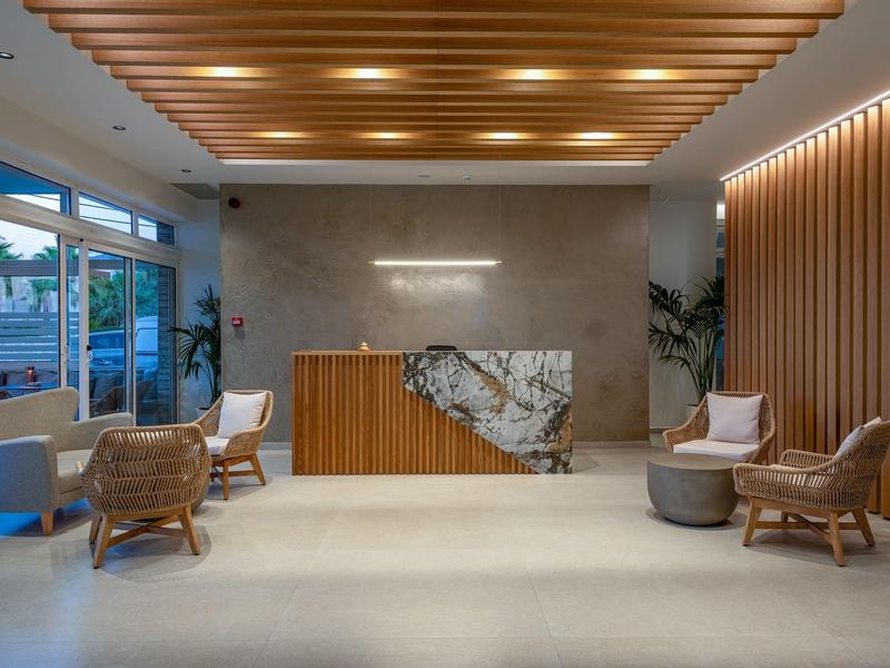 Moderně zařízená recepce s dřevěnými prvky a pohodlnými sedacími místy v hotelu.