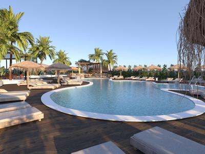 Velký zakřivený bazén s lehátky a palmami pod slunečnou oblohou.