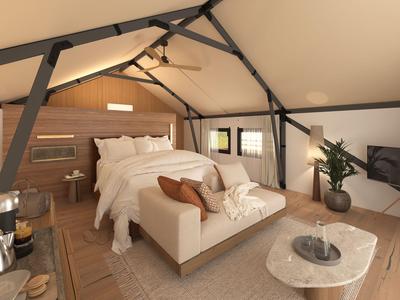 Moderní podkrovní ložnice s velkou postelí, pohovkou a stylovým zařízením.