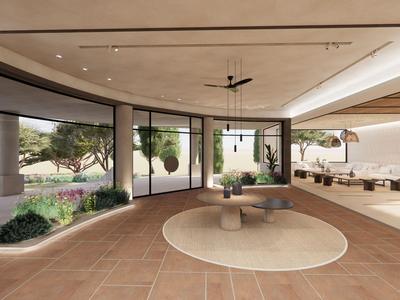 Area lounge moderna e aperta con grandi finestre che si affacciano su un giardino.